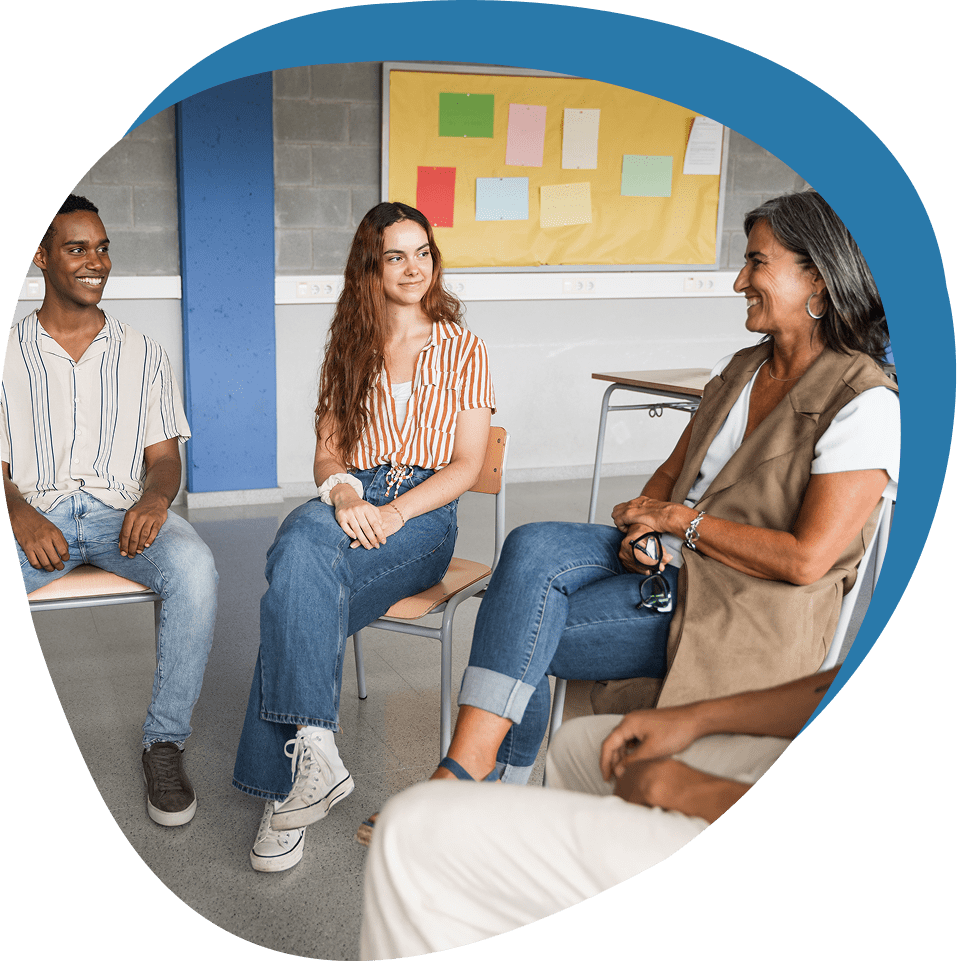 Group of four people having a discussion in a casual setting.